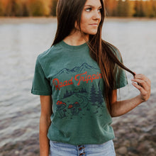 Load image into Gallery viewer, A woman wearing a green shirt with red mushrooms on it And it says road trippin 
