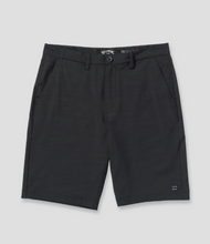 Load image into Gallery viewer, Black shorts with brand logo on a light gray background
