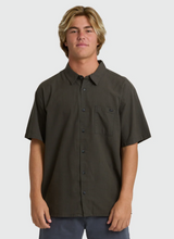 Load image into Gallery viewer, Man wearing a dark brown button-up shirt on a white background
