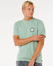 Load image into Gallery viewer, Man wearing a light green t-shirt with a logo on a white background
