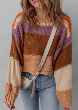 Load image into Gallery viewer, Person wearing a colorful striped sweater with a gray background
